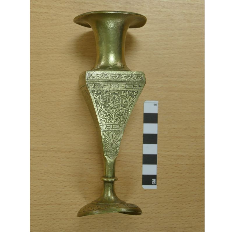 <em>An engraved brass vase – which may have been for floral arrangements or may have been purely decorative.
<p></p></em>